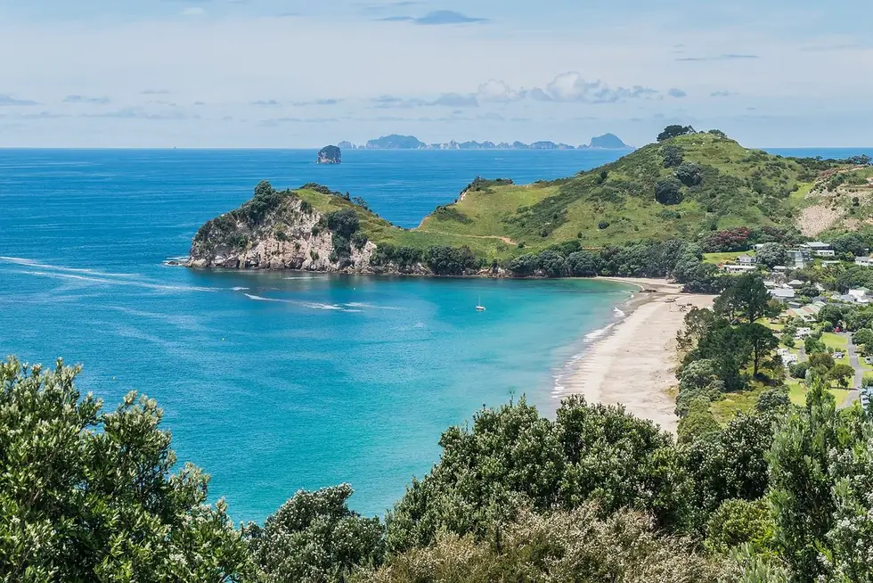 Hahei Beach — offshore islands break the swell, leaving the bay calm