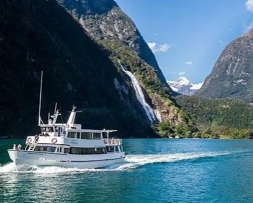 The cruise boat beneath the falls in Milford Sound