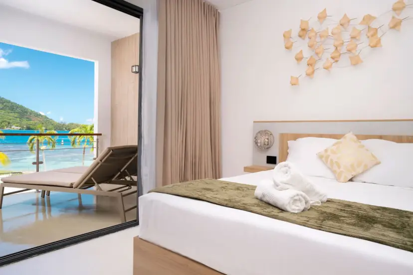 A one-bedroom suite at Cook's Bay Hotel & Suites, opening onto a terrace above the bay