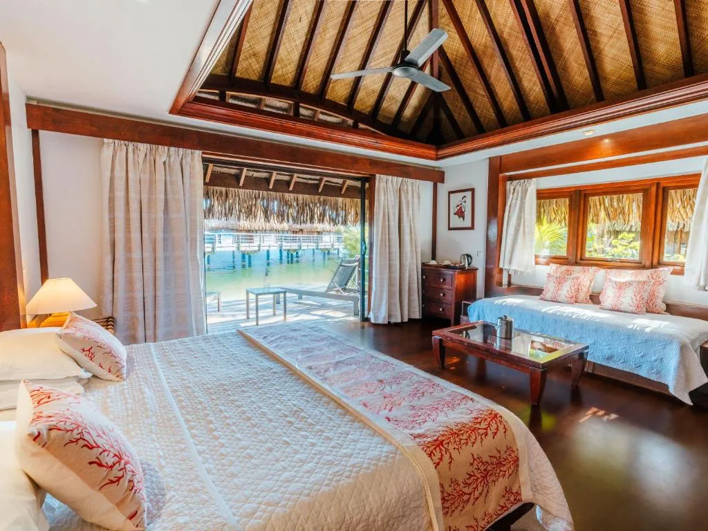 Inside an overwater bungalow at Manava, opening onto the deck and the lagoon