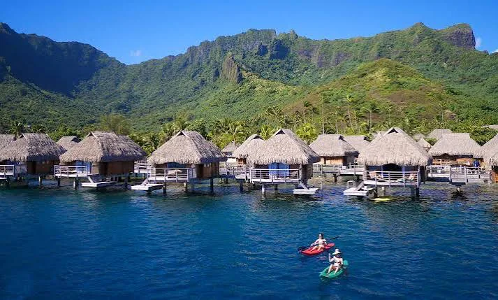 Overwater bungalows at Manava, set close together with the mountains behind