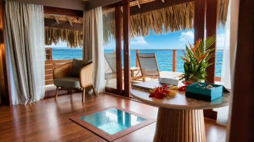 Inside an overwater villa at Sofitel Kia Ora, with the glass viewing panel set into the floor